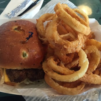 Rooster's Restaurant - 6oz cheeseburger on jalapeño bun w/onion rings - American Near Me - Jackson, Mississippi