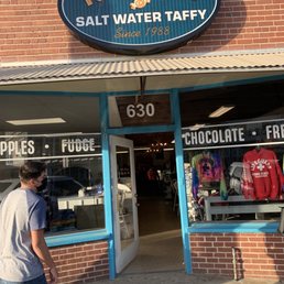 a man walking in front of the store a man walking in front of the store