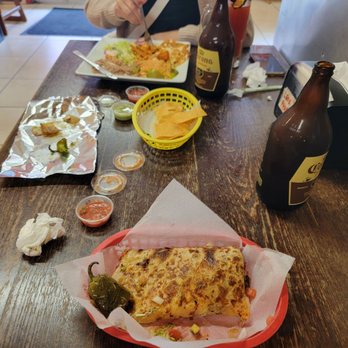 El Rancho Grande - Half of the carne asada quesadilla and the chilaquiles plate in the background. - Mexican Near Me - San Francisco, California El Rancho Grande - Half of the carne asada quesadilla and the chilaquiles plate in the background. - Mexican Near Me - San Francisco, California
