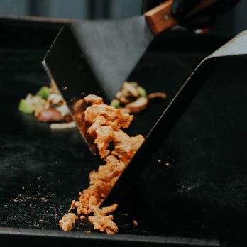Nandos Hot Box - a person cutting food - Tacos Near Me - San Diego, California Nandos Hot Box - a person cutting food - Tacos Near Me - San Diego, California