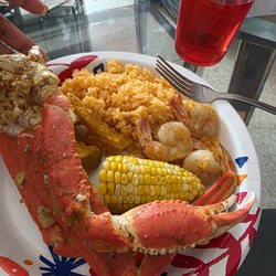 Crab legs, shrimp, yellow rice n corn on cobb.