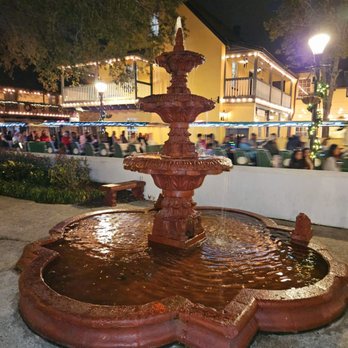 The Columbia - The water fountain at the entrance with tourists walking by - Spanish Near Me - St Augustine, Florida The Columbia - The water fountain at the entrance with tourists walking by - Spanish Near Me - St Augustine, Florida