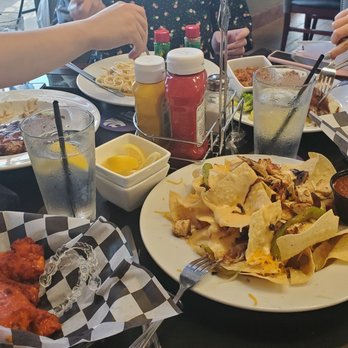 Colbert Hills - a group of people sitting at a table with plates of food - Beer, Wine & Spirits Near Me - Manhattan, Kansas