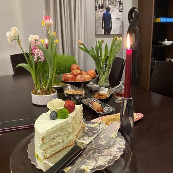Shirini Sara - a table with a cake and a candle - Bakeries Near Me - North York, Ontario