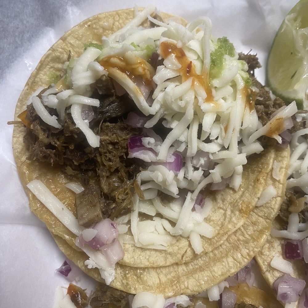 Beef Head Taco with cheese and hot sauce.