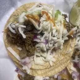 Beef Head Taco with cheese and hot sauce.