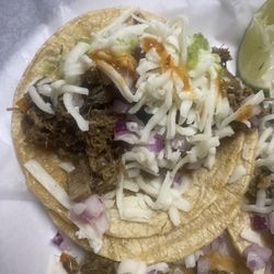 Super Tacos Y Tortas El Neno - Beef Head Taco with cheese and hot sauce.
