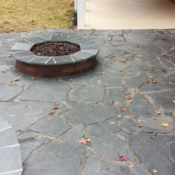 Harvell Landscaping - Slate stone patio with seat wall, raised planters, gas fire pit, and lighting. - Landscaping Near Me - Clayton, North Carolina