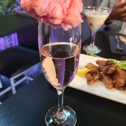 a glass of pink cotton candy
