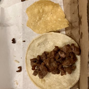 Mariscos Altamar - Disappointing taco - A taco with cooked meat on a soft tortilla is placed on a paper-lined surface, accompanied by a crispy chip. The setting appears to be a casual dining environment. - Seafood Near Me - Los Lunas, New Mexico