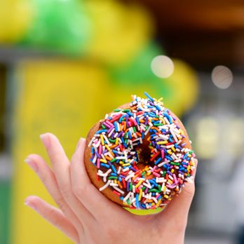 Lee's Donuts - a hand holding a sprinkled donut - Donuts Near Me - Langley, British Columbia Lee's Donuts - a hand holding a sprinkled donut - Donuts Near Me - Langley, British Columbia