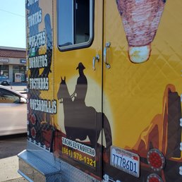a taco truck parked on the side of the road a taco truck parked on the side of the road