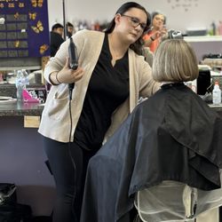Monarch School Of Cosmetology - Adding finishing touches to her client.