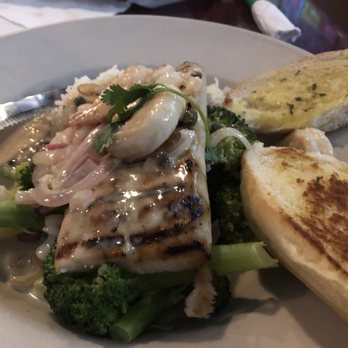 Three Dollar Cafe - Grilled Mahi-mahi with a caper sauce on top of broccoli and garlic bread - Chicken Wings Near Me - McDonough, Georgia Three Dollar Cafe - Grilled Mahi-mahi with a caper sauce on top of broccoli and garlic bread - Chicken Wings Near Me - McDonough, Georgia