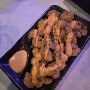 Polygon Brooklyn - a plate of fried food with sauce - Latin American Near Me - Brooklyn, New York