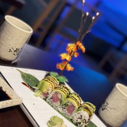 Osaka Sushi & Hibachi - Tuna sushi/ cucumber inside/ avocado plus sesame seeds and eel sauce atop