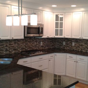 Capital Contracting - Kitchen cabinets sprayed twice in oil base and finished in two coats of Emerald semi gloss. Harware installed afterwards. (1) - Painters Near Me - Dyer, Indiana
