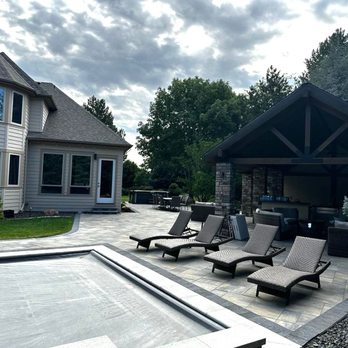 Verdante Landscape & Hardscape - Paver patio with black edging with outdoor kitchen and pool. Massive patio to enjoy time with family and friends! - Landscaping Near Me - Meridian, Idaho