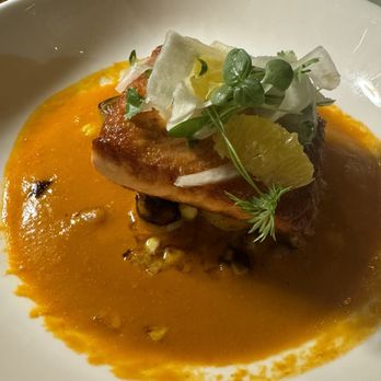 Glass Kitchen - Salmon special on a bed of mini potatoes, leek, corn in a bed of tomato bisque.   Delicious and so flavourful - Breakfast & Brunch Near Me - Markham, Ontario