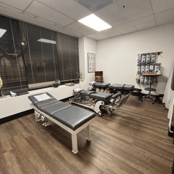 Harbor Bay Chiropractic - Treatment area equipped with different tables that allow multiple treatment techniques and to help out patients who may be less mobile.