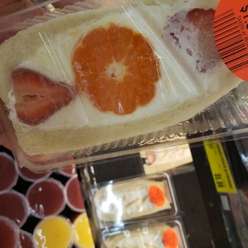 Sweet Haato - a person holding a sandwich with fruit on it - Sandwiches Near Me - Honolulu, Hawaii
