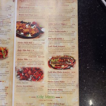 Curry Masala - Spring - The menu from Curry Masala in Spring, TX, displays a variety of Indo-Pak cuisine options including grilled kebabs, chicken, lamb, and beef dishes. It features items such as Masala Goat Chops, Chicken Malai Boti, and Gosht Khor Platter, with prices and descriptions. The menu also includes a kids' menu with chicken tenders, nuggets, and a grilled chicken burger, along with a section for sides like waffle fries. The menu is printed on paper with colorful headings and detailed dish descriptions. - Indian Near Me - Spring, Texas
