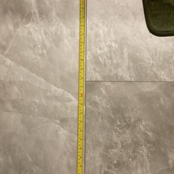 Lowe's Home Improvement - Measurements of a 24" tile that should have been divided in half for the next row.