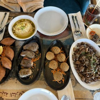 Sah El Nom - (left to right) kibbeh, (top) hummus, mahshi batinjan, falafel, and kibdeh - Middle Eastern Near Me - Worth, Illinois Sah El Nom - (left to right) kibbeh, (top) hummus, mahshi batinjan, falafel, and kibdeh - Middle Eastern Near Me - Worth, Illinois
