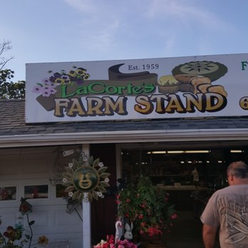 LA CORTE FARM STAND - a man walking in front of a store - Farmers Market Near Me - Moriches, New York LA CORTE FARM STAND - a man walking in front of a store - Farmers Market Near Me - Moriches, New York