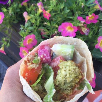 Markouk Bread - a hand holding a pita filled with vegetables - Lebanese Near Me - Gloucester, Massachusetts