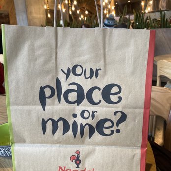 Nando's Peri-Peri - I love all of the signs throughout the establishment.  This is our goodie bag carrying just a "little leftovers" home. - Portuguese Near Me - Chicago, Illinois