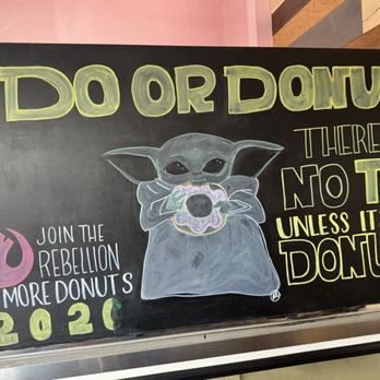 BC’s Donuts - A chalkboard sign features a drawing of Baby Yoda holding a donut, with text that reads 'DO OR DONUT,' 'THERE IS NO TRY UNLESS IT'S A DONUT,' and 'JOIN THE REBELLION EAT MORE DONUTS 2020.' The sign promotes a donut shop and uses playful language and artwork to attract customers. - Donuts Near Me - Pasadena, California