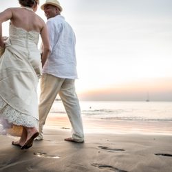 Ueda Photography - Groom and Bride walking on the beach during sunset in Costa Rica.
