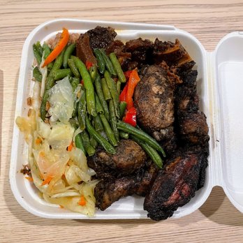 Flames - Loaded medium combo plate of Stewed Oxtail, Jerk Wings, vegetables, and rice and beans underneath - Caribbean Near Me - Providence, Rhode Island