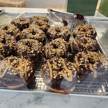 Deaux - chocolate covered donuts on a cooling rack - Donuts Near Me - Redlands, California