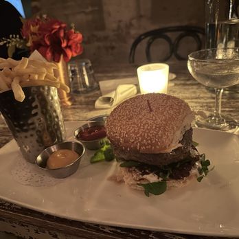 Tanner Smiths - 8 oz. 28 day dry-aged burger, marrow butter, French onion marmalade, horseradish crema, sesame potato bun, baby watercress. - Cocktail Bars Near Me - New York, New York