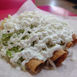 Taquitos dorados- two beef, two chicken. Lettuce, queso fresco, crema. So delicious, outstanding.