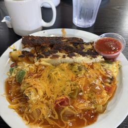 Rancho Omelette Steak, mushroom, onion, bell pepper and cheddar. Topped with ranchera sauce Rancho Omelette Steak, mushroom, onion, bell pepper and cheddar. Topped with ranchera sauce