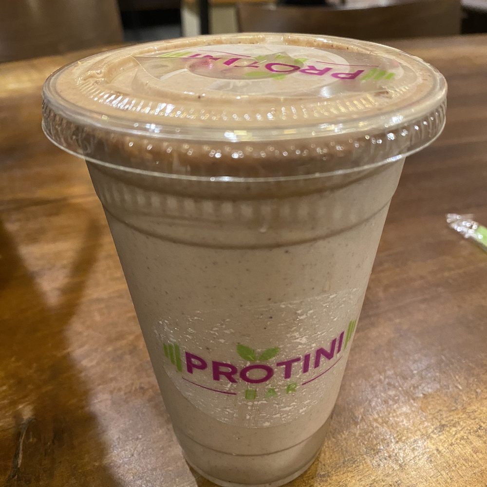 Protini Bar - Banana, plant-based protein, hemp granola, cacao nibs, almond butter, cold brew, almond milk - Juice Bars & Smoothies Near Me - Woodland Hills, California Protini Bar - Banana, plant-based protein, hemp granola, cacao nibs, almond butter, cold brew, almond milk - Juice Bars & Smoothies Near Me - Woodland Hills, California