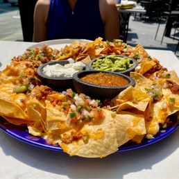 The nachos kicked up with guacamole, sour cream, salsa and pieces of chicken - can you say "ole!" The nachos kicked up with guacamole, sour cream, salsa and pieces of chicken - can you say "ole!"