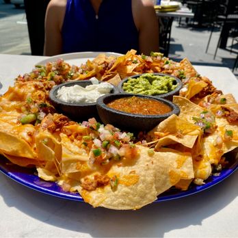 Moxies Toronto Downtown Restaurant - The nachos kicked up with guacamole, sour cream, salsa and pieces of chicken - can you say "ole!" - Lounges Near Me - Toronto, Ontario Moxies Toronto Downtown Restaurant - The nachos kicked up with guacamole, sour cream, salsa and pieces of chicken - can you say "ole!" - Lounges Near Me - Toronto, Ontario