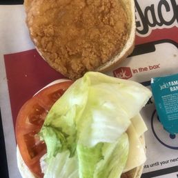 Chicken sandwich, lettuce tomato and cheese with a side of ranch dressing Chicken sandwich, lettuce tomato and cheese with a side of ranch dressing