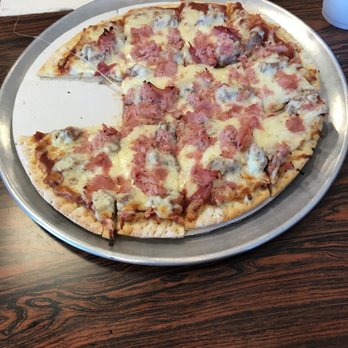 La Gondola Spaghetti House - Ham and sausage pizza. My dad clearly couldn't wait to dive in. - Italian Near Me - Bloomington, Illinois La Gondola Spaghetti House - Ham and sausage pizza. My dad clearly couldn't wait to dive in. - Italian Near Me - Bloomington, Illinois