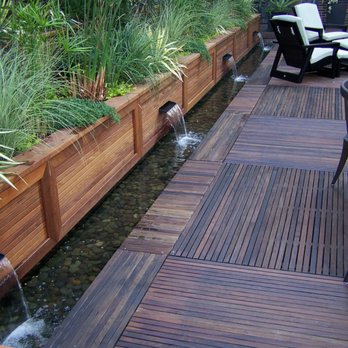 Plant Professionals - a wooden deck with a water feature - Landscaping Near Me - Miami, Florida