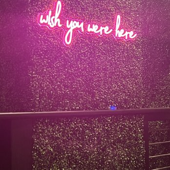 The Monkey Bar - a neon sign that says wish you were here - Bars Near Me - Fairhope, Alabama