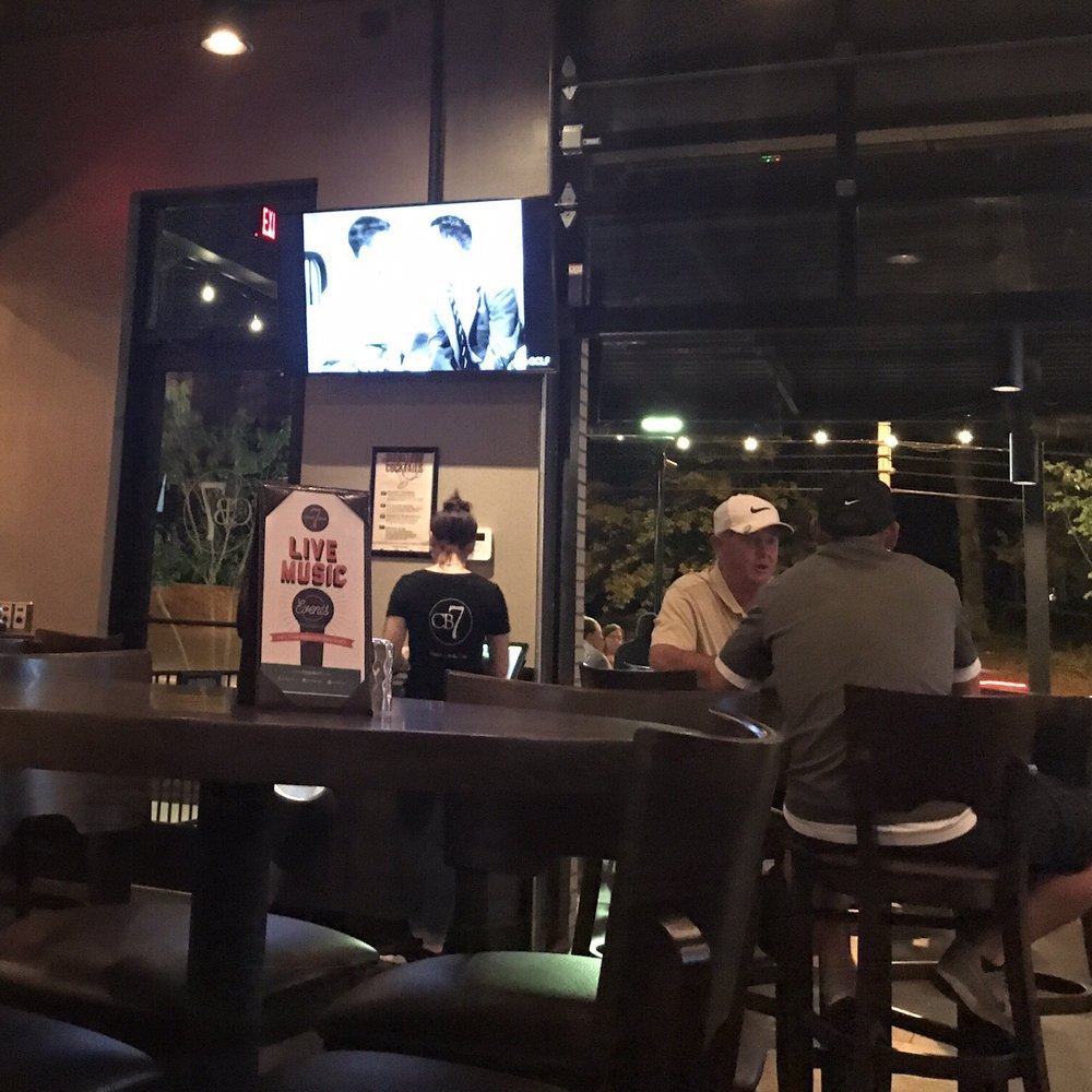 CharBar No 7 - Looking out the open glass, garage door toward the front, covered patio seating. - Bars Near Me - Mint Hill, North Carolina