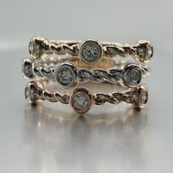 14 Karat tri-gold natural diamond band.