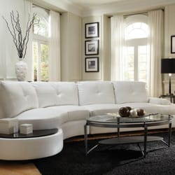 Comfy Furniture - White bonded leather sectional and offers a wooden top table at the end of sectional for drinks and snacks