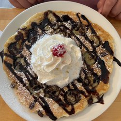 FM Station Cafe - One huge pancake with banana and chocolate topped with whipped cream and a cherry. The kids will love this dish!