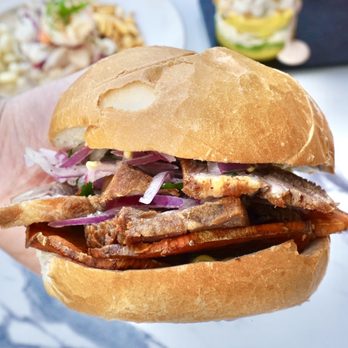 Latin Bites - a hand holding a sandwich - Latin American Near Me - Houston, Texas Latin Bites - a hand holding a sandwich - Latin American Near Me - Houston, Texas